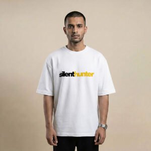 Man wearing a white oversized t-shirt with silenthunter printed in black and yellow across the chest